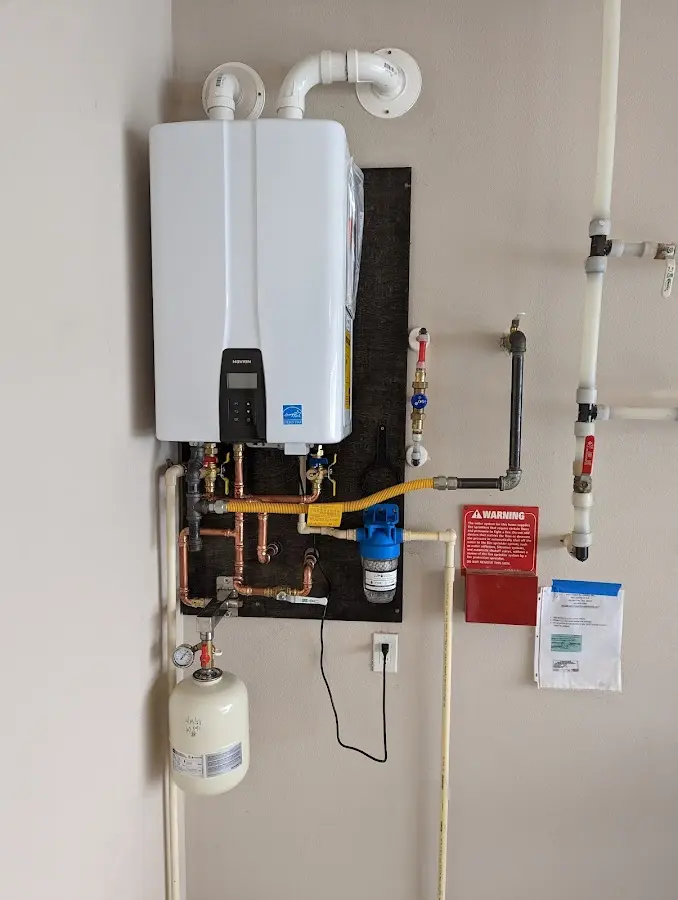 Professional plumber installing copper piping in a Prairieville home